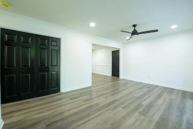 empty room featuring ceiling fan and hardwood / wood-style flooring