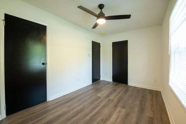 unfurnished bedroom with ceiling fan, a closet, and hardwood / wood-style floors