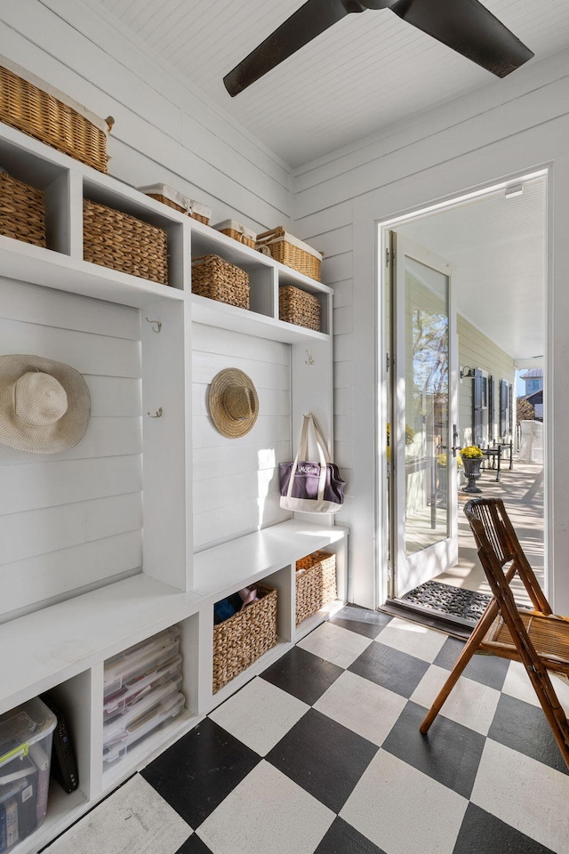 mudroom featuring wood walls