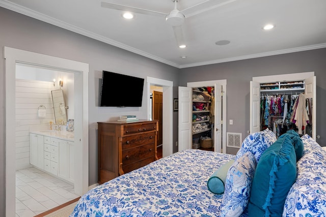 bedroom with ceiling fan, sink, ensuite bathroom, a closet, and ornamental molding