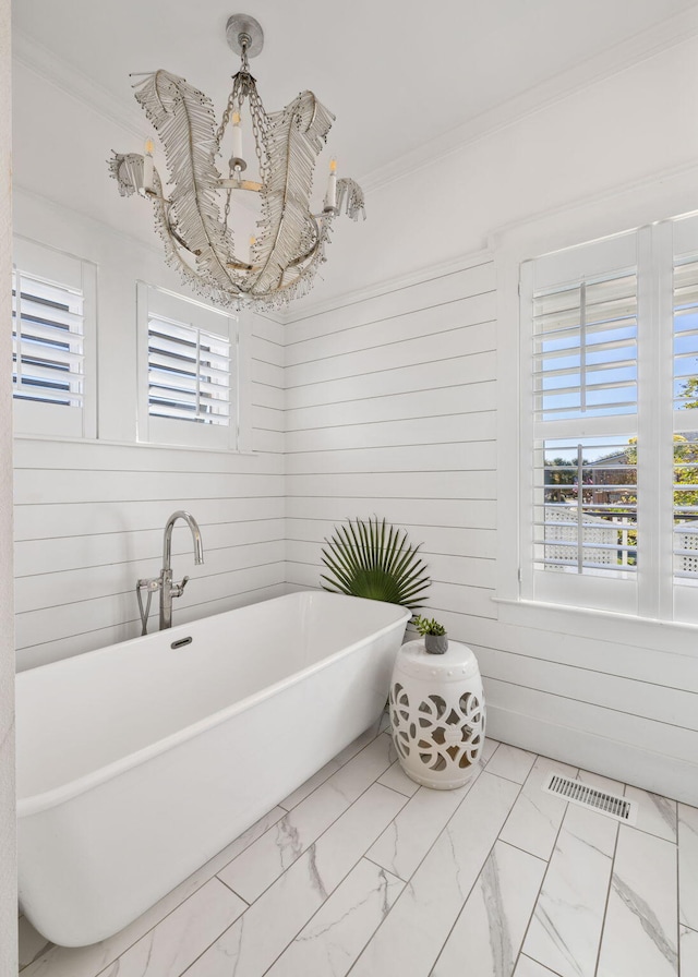 bathroom with a bathtub, crown molding, and wooden walls