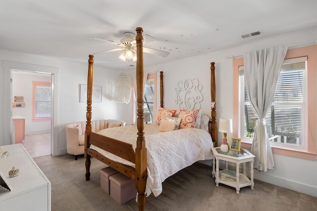 carpeted bedroom with multiple windows and ceiling fan