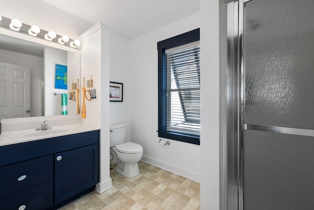 bathroom with an enclosed shower, vanity, and toilet