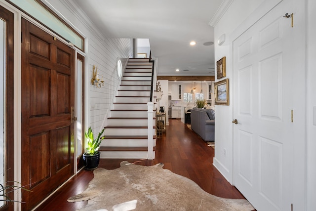 entrance foyer with dark hardwood / wood-style flooring and ornamental molding