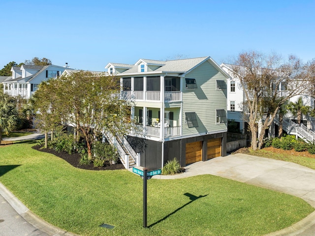 exterior space with a balcony, a front yard, and a garage