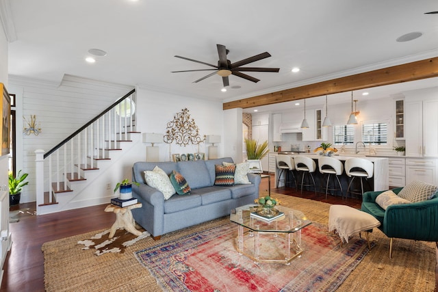 living room with crown molding, ceiling fan, and dark wood-type flooring