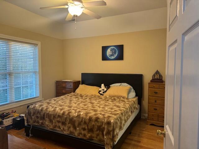 bedroom featuring ceiling fan and dark wood-type flooring