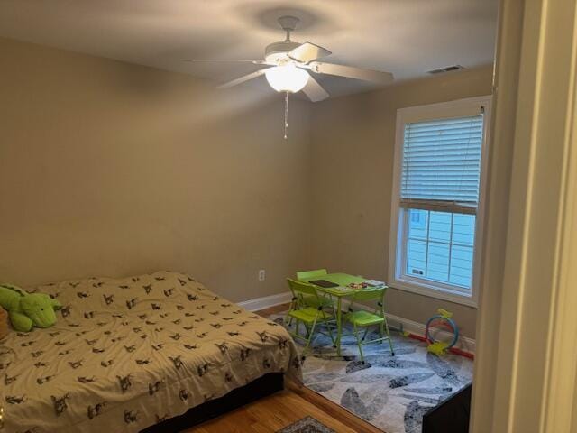 bedroom with hardwood / wood-style floors and ceiling fan