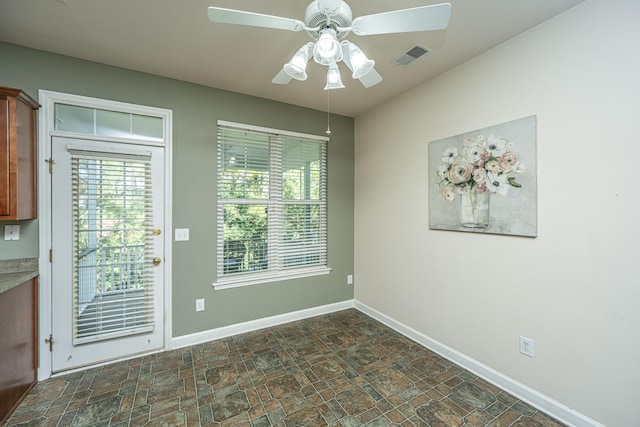 doorway with ceiling fan