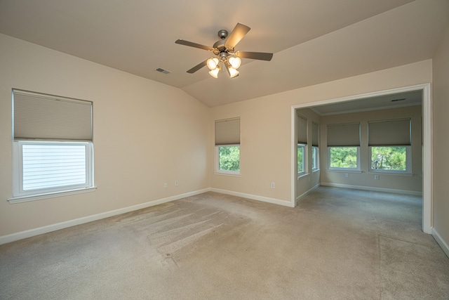 carpeted spare room with ceiling fan and lofted ceiling