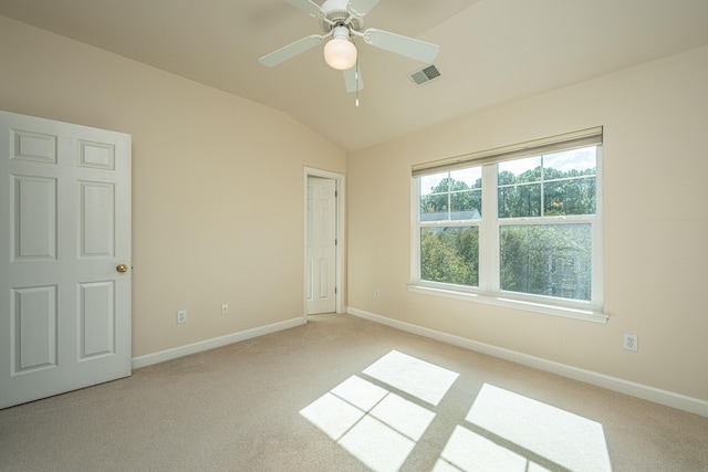 unfurnished bedroom with light colored carpet, ceiling fan, and lofted ceiling