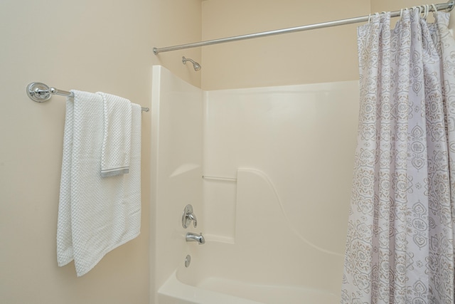 bathroom with shower / bathtub combination with curtain