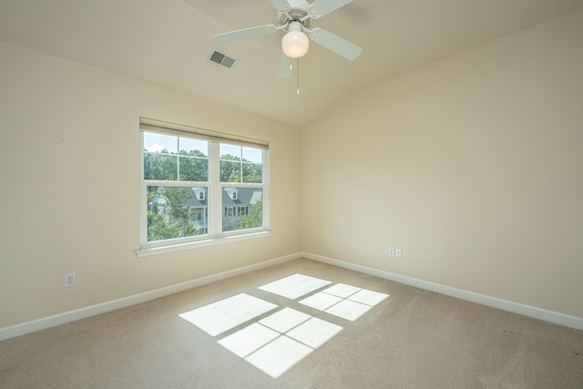 carpeted empty room featuring ceiling fan and lofted ceiling