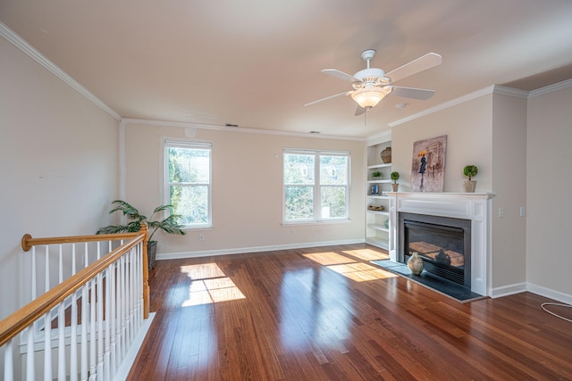 unfurnished living room featuring built in shelves, ceiling fan, dark hardwood / wood-style flooring, and ornamental molding