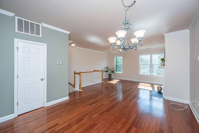 unfurnished room with dark hardwood / wood-style flooring, crown molding, and a notable chandelier