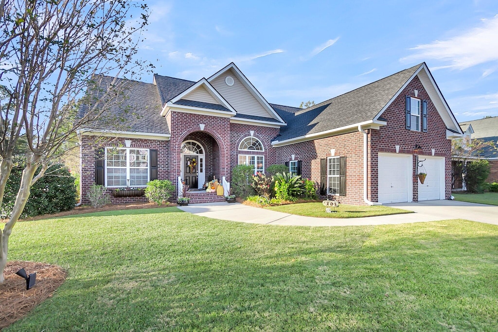 view of front facade with a garage and a front lawn