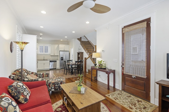 living area featuring recessed lighting, stairway, wood finished floors, and ornamental molding