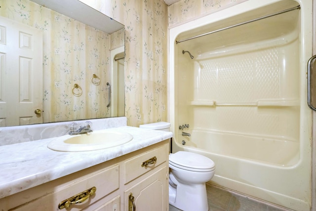 full bathroom with shower / bath combination, tile patterned floors, vanity, and toilet