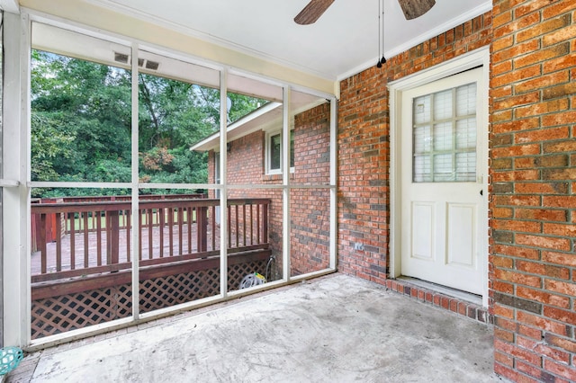 unfurnished sunroom featuring ceiling fan