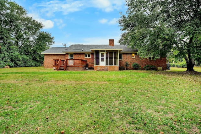 back of house featuring a wooden deck, a sunroom, and a yard