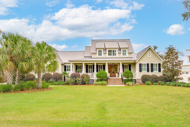 4215 Ten Shillings Way, Ravenel, SC 29470 - view of front of home featuring covered porch, a standing seam roof, a front yard, and metal roof