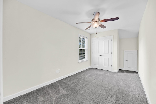 unfurnished bedroom with baseboards, a ceiling fan, a closet, and carpet flooring