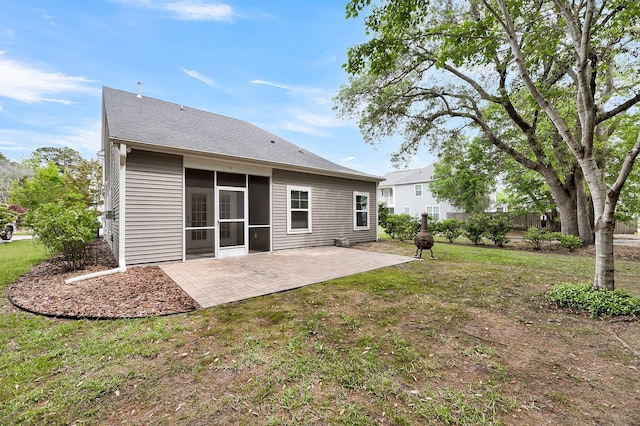 back of house featuring a patio, fence, a yard, and a sunroom