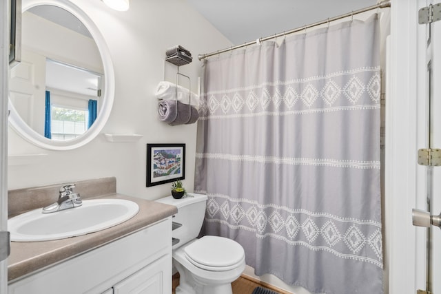 bathroom featuring vanity, toilet, and a shower with shower curtain