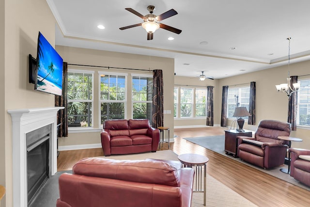 522 Tidewater Chase Ln, Summerville, SC 29486 - living room with ornamental molding, a glass covered fireplace, wood finished floors, baseboards, and ceiling fan with notable chandelier