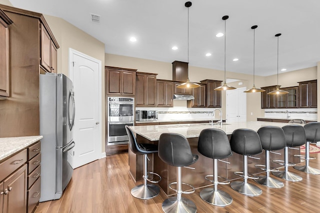 522 Tidewater Chase Ln, Summerville, SC 29486 - kitchen with light wood-style floors, decorative backsplash, stainless steel appliances, and visible vents
