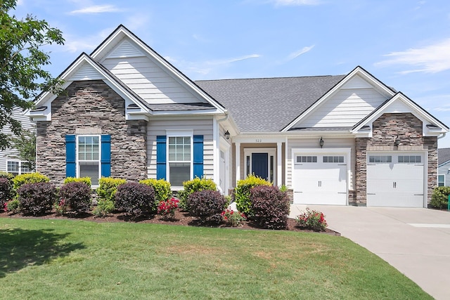 522 Tidewater Chase Ln, Summerville, SC 29486 - craftsman house with a shingled roof, a front lawn, stone siding, a garage, and driveway