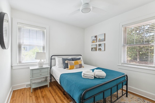 bedroom with baseboards, ceiling fan, and wood finished floors