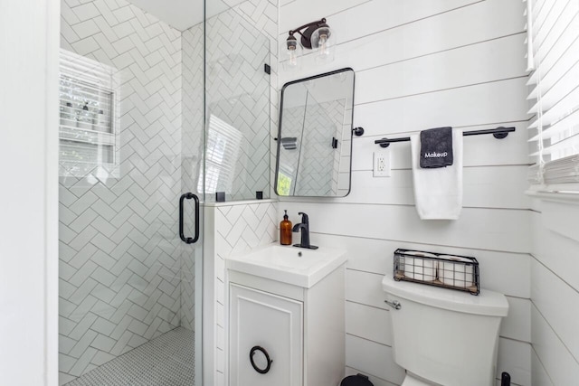 full bath featuring vanity, a shower stall, and toilet