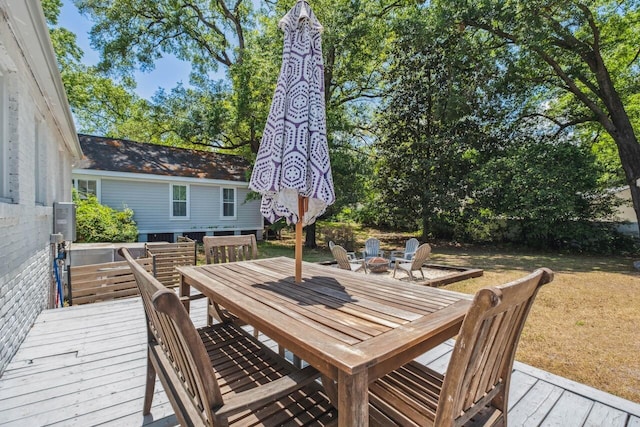 wooden terrace featuring outdoor dining space