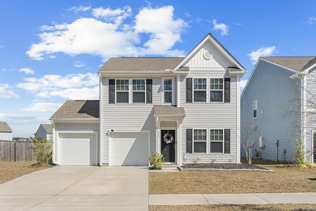 traditional home featuring concrete driveway, roof with shingles, an attached garage, fence, and board and batten siding