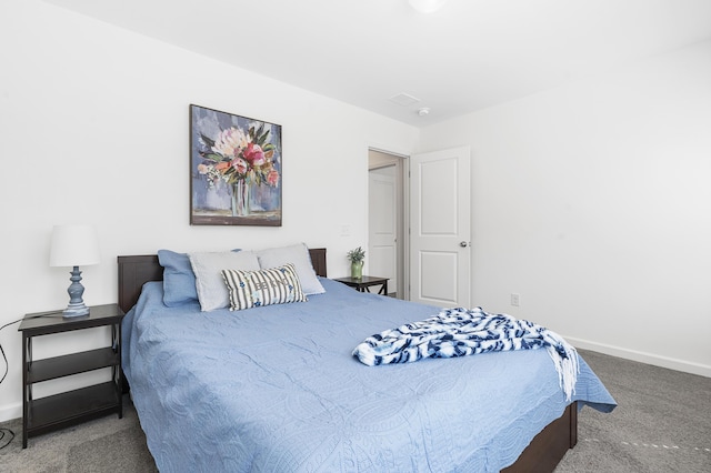 bedroom featuring carpet and baseboards