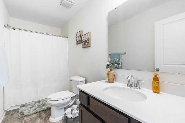 bathroom featuring toilet, vanity, visible vents, and a shower with curtain