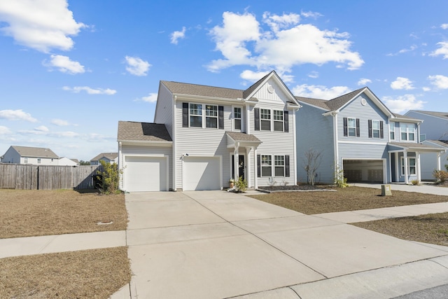 view of front of home with a garage, fence, and concrete driveway