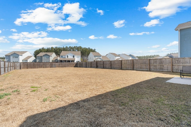 view of yard with a fenced backyard and a residential view