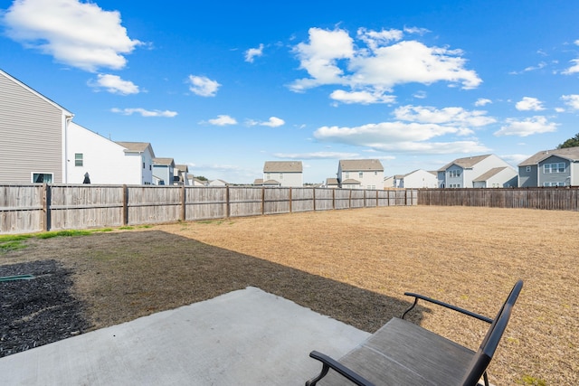 view of yard with a fenced backyard and a residential view