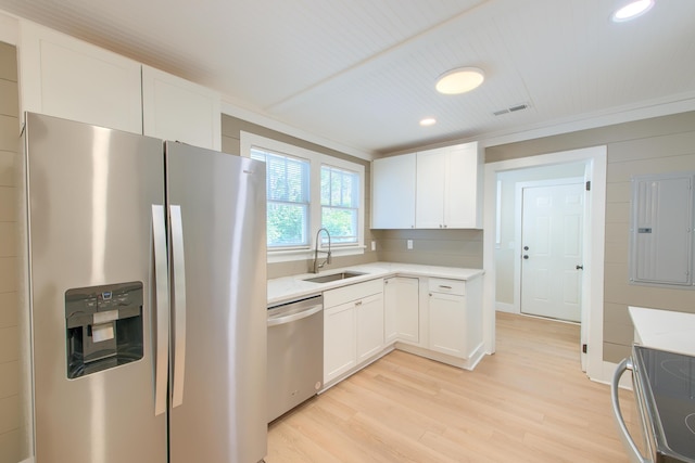 208 State St, Walterboro, SC 29488 - kitchen with stainless steel appliances, a sink, light countertops, light wood finished floors, and white cabinets