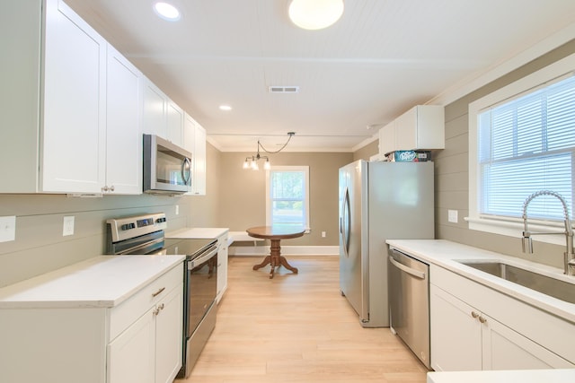 208 State St, Walterboro, SC 29488 - kitchen featuring stainless steel appliances, a sink, light wood-type flooring, white cabinets, and recessed lighting