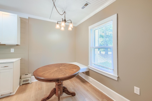208 State St, Walterboro, SC 29488 - dining space featuring crown molding, light wood-type flooring, a chandelier, and baseboards