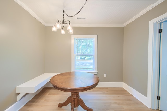 208 State St, Walterboro, SC 29488 - dining space featuring light wood-style floors, ornamental molding, a chandelier, and baseboards