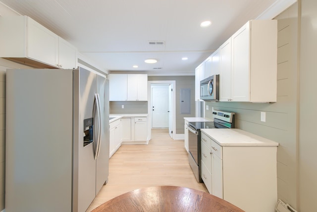 208 State St, Walterboro, SC 29488 - kitchen with stainless steel appliances, light wood finished floors, light countertops, white cabinets, and recessed lighting