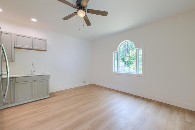 208 State St, Walterboro, SC 29488 - unfurnished living room featuring a sink, light wood-style floors, baseboards, recessed lighting, and ceiling fan