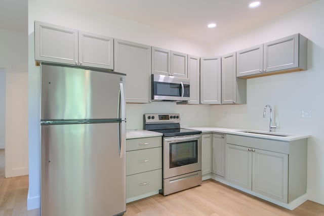208 State St, Walterboro, SC 29488 - kitchen featuring stainless steel appliances, a sink, light wood-style floors, light countertops, and gray cabinetry