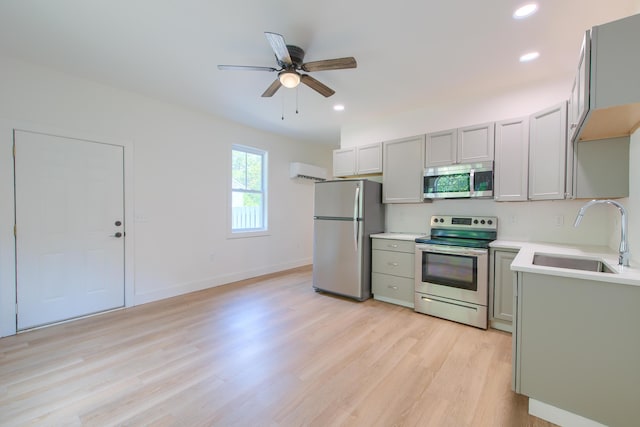 208 State St, Walterboro, SC 29488 - kitchen featuring appliances with stainless steel finishes, a sink, gray cabinetry, ceiling fan, and light wood finished floors