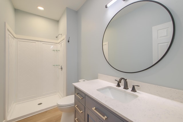 208 State St, Walterboro, SC 29488 - full bath featuring vanity, toilet, a stall shower, wood finished floors, and recessed lighting
