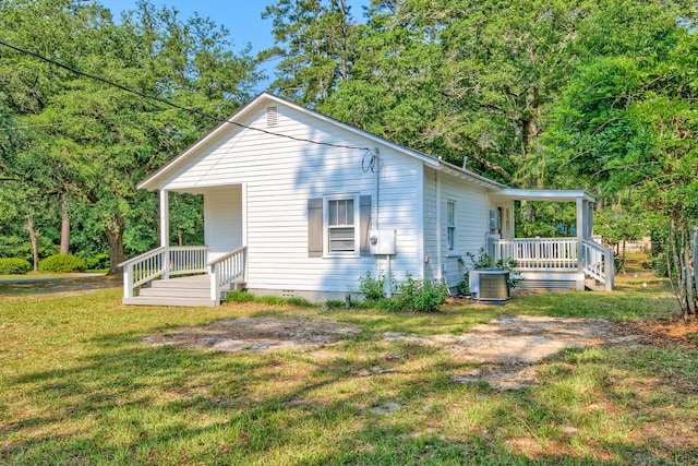 208 State St, Walterboro, SC 29488 - view of home's exterior with covered porch, a yard, and cooling unit